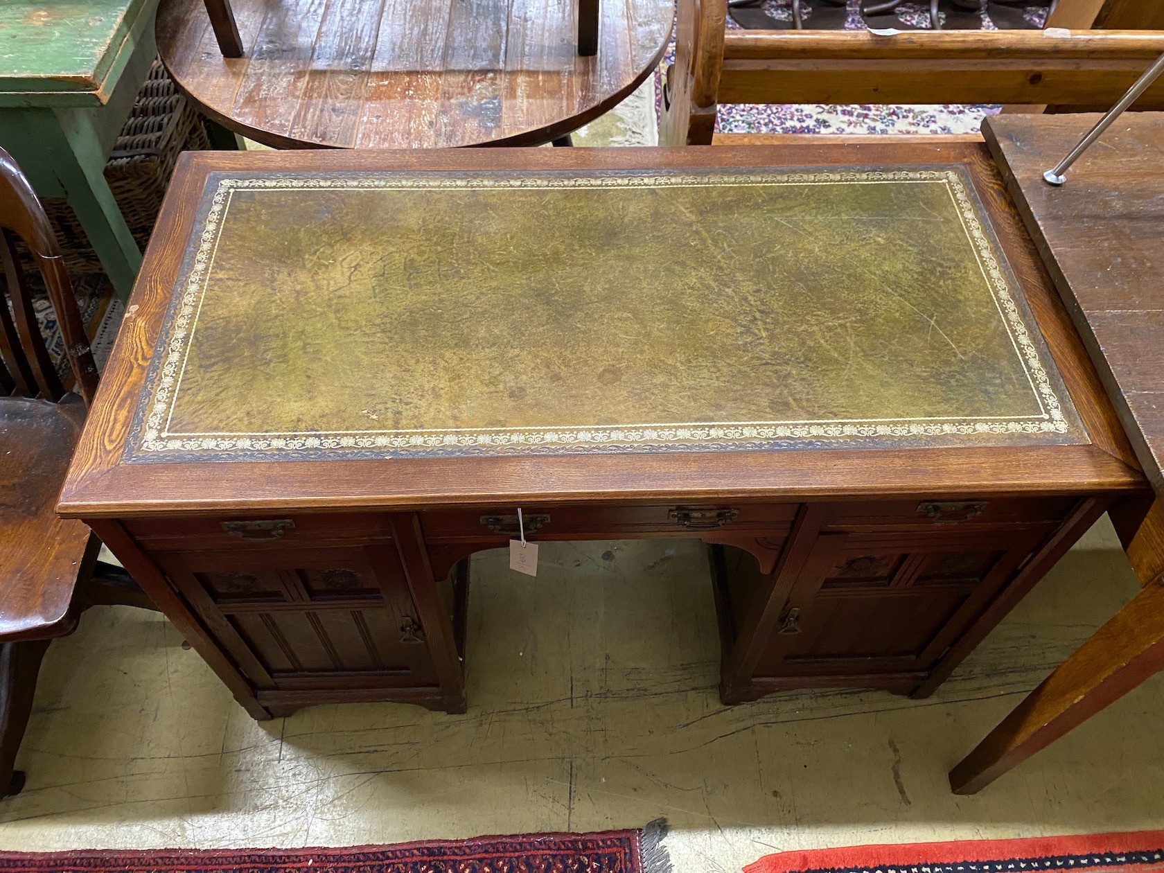 A late Victorian Aesthetic movement oak kneehole writing table, width 120cm, depth 60cm, height 74cm